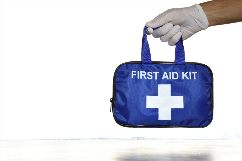 Hand holding a first aid kit