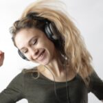 Woman listening to music and wearing headphones